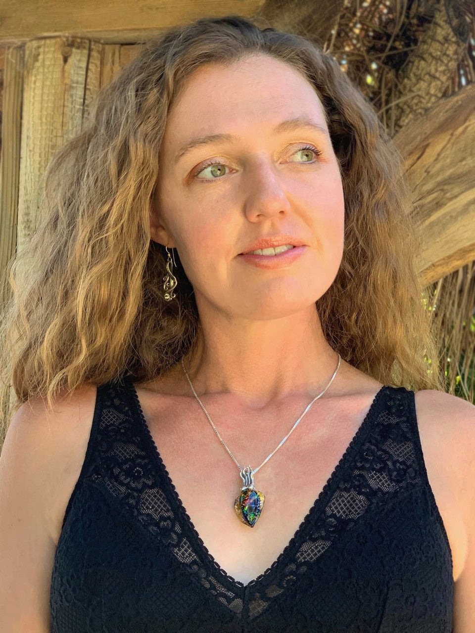 The Dichroic Glass Iridescent Cuttlefish Pendant modeled by the artist, Alisha McCormack.