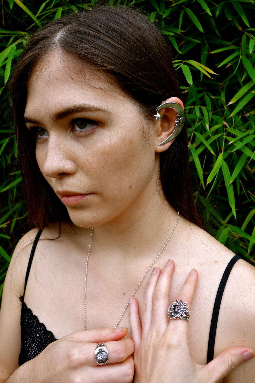 Teresa is pictured wearing the sterling silver Moon and Star ring, Moon ear wrap, and Eclipse ring.