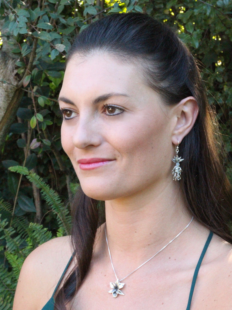 Model is wearing Mandrake Root Earrings & Orchid Charm