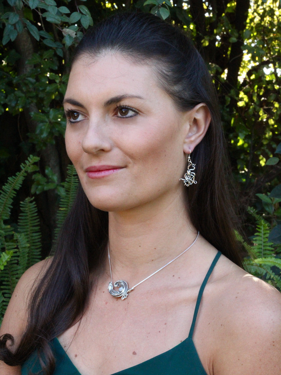 Jessica is wearing Octopus and Mermaid Earrings & Rip Curl Wave Pendant w/ Gemstone