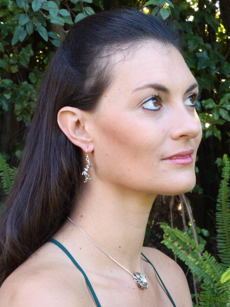 Jessica is wearing Octopus and Mermaid Earrings & Rip Curl Wave Pendant w/ Gemstone