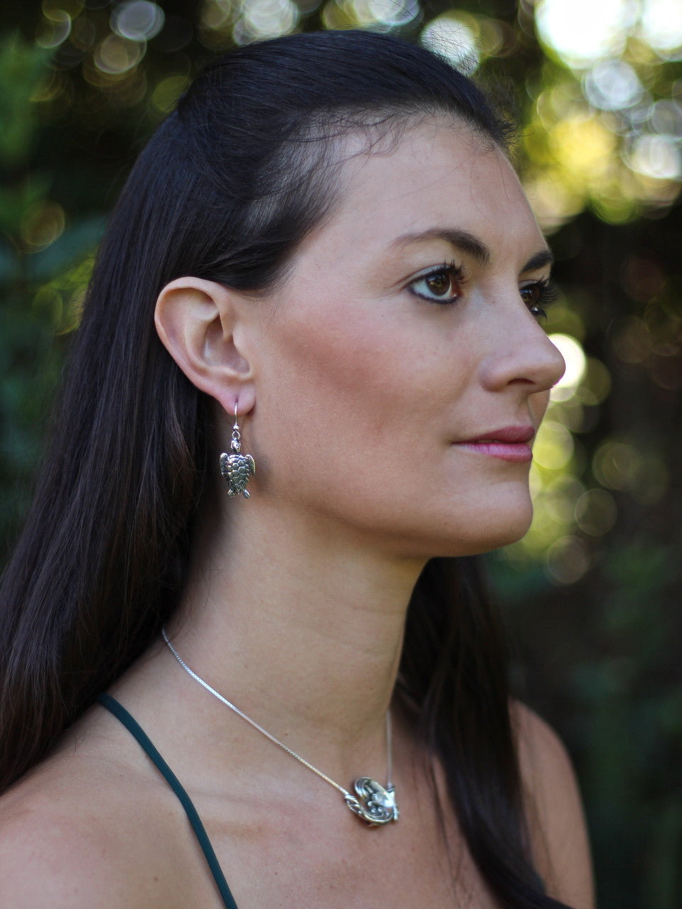 Model is wearing the Sea Turtle earrings & Rip Curl Wave Pendant with Gemstone