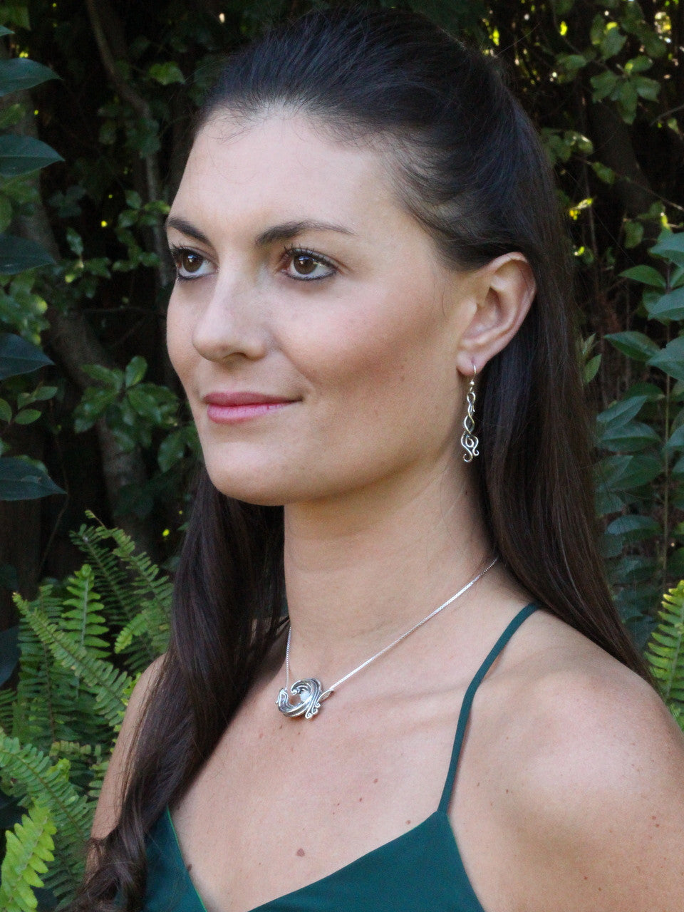 Model is wearing Rip Curl Wave Pendant and Wave Drop Spiral Earrings in sterling silver