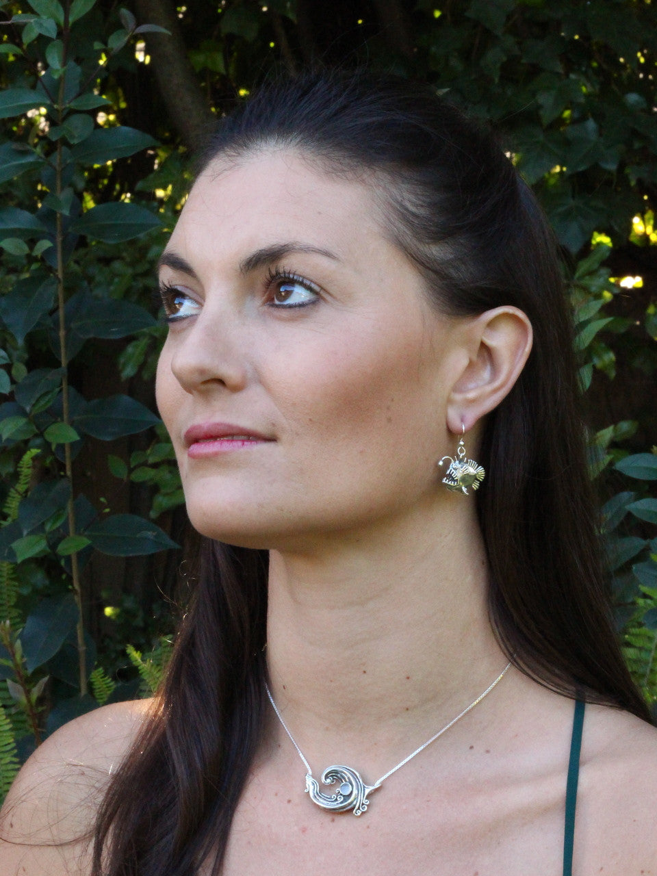 Model is wearing Rip Curl Wave Pendant w/ Gemstone & Angler Fish Earrings