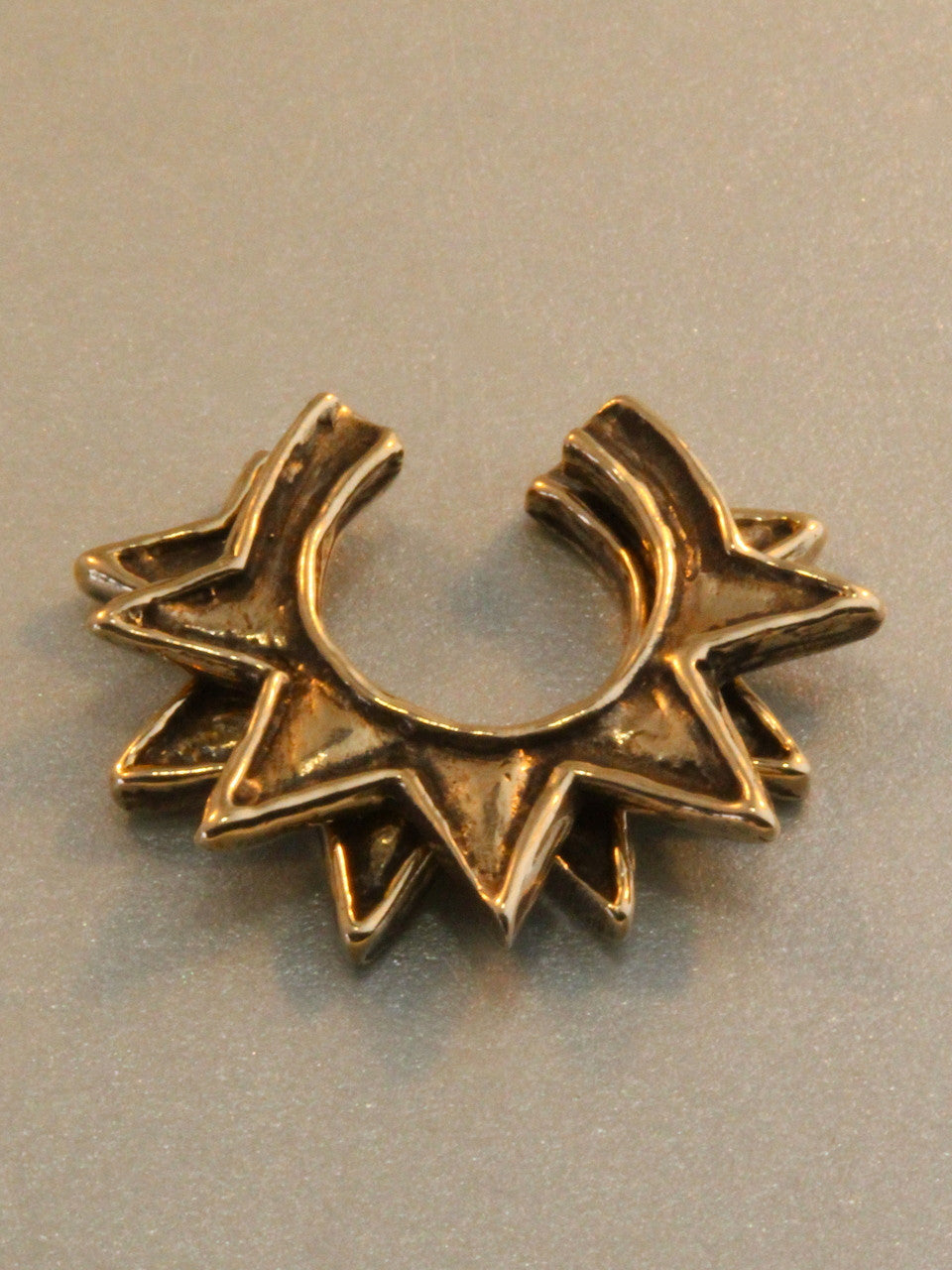 Pair of stackable bronze Ninja Star Ear cuffs.