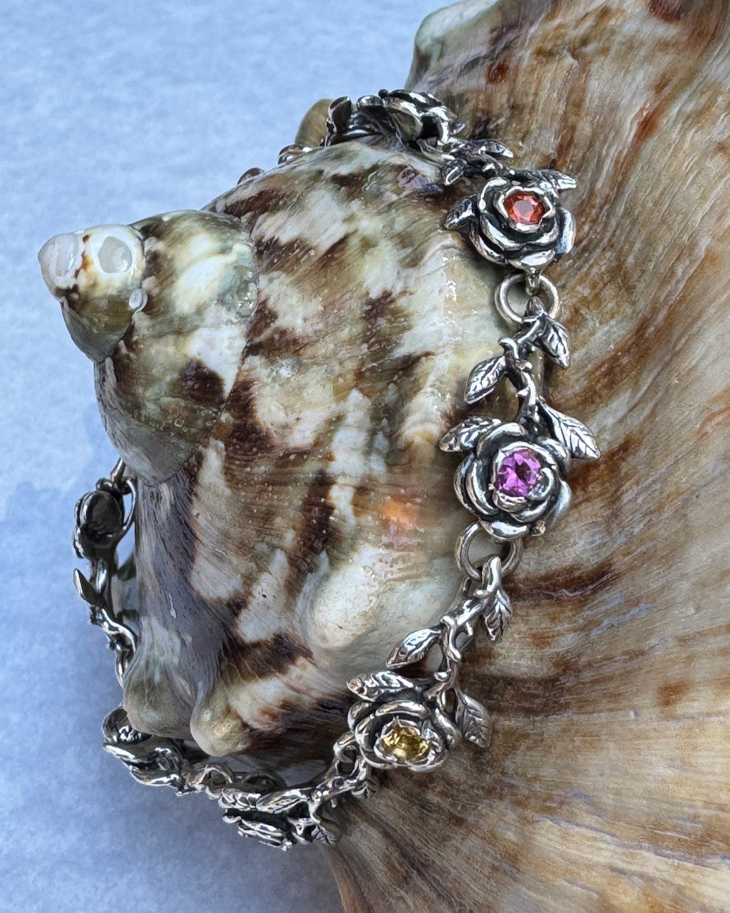 Rose Bracelet with assorted semi precious gemstones - 2 x Citrine, 1 x
Pink Tourmaline, 1 x Rhodolite Garnet, 2 x Mexican Opal, 2 x Amethyst -Silver