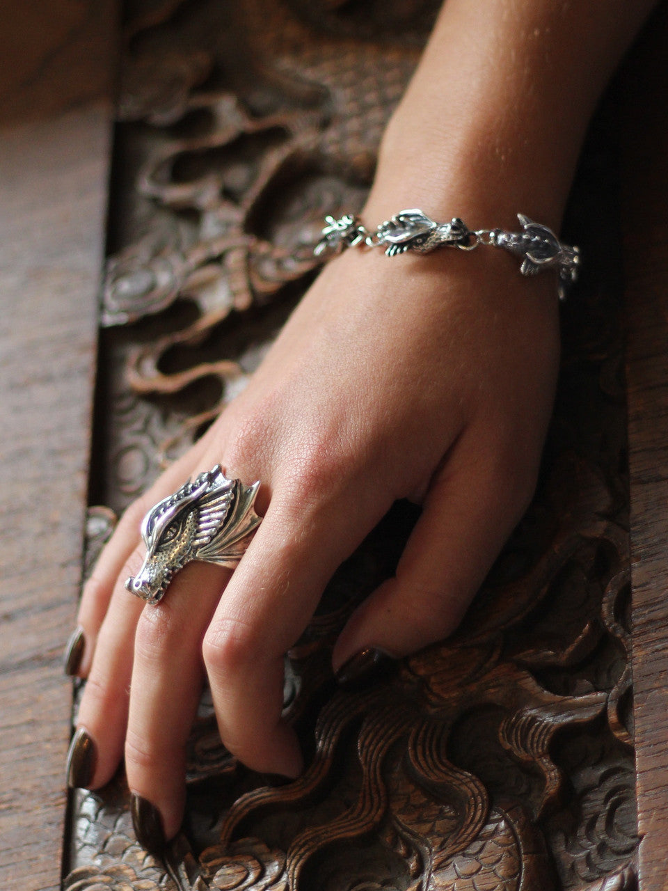 Model is wearing the sterling silver Gothic Dragon Head Link Bracelet and Valor Dragon Ring