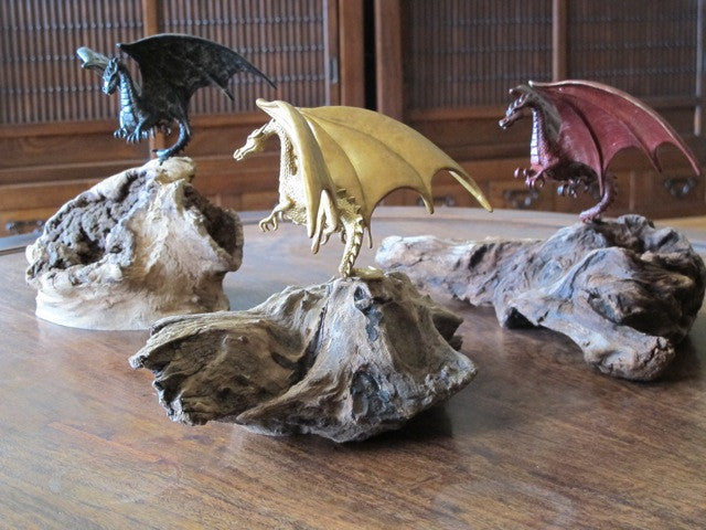 Three Flight of Fancy Dragon Sculptures in a variety of patinas.